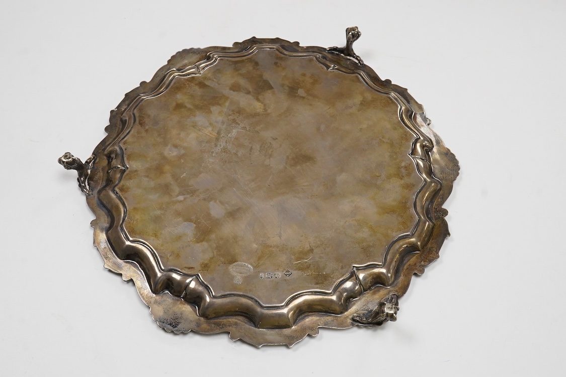 A late Victorian silver salver, with shell and scroll border and engraved inscription, on three claw and ball feet, Mappin Brothers, Sheffield, 1896, 26.4cm, 15.2oz.